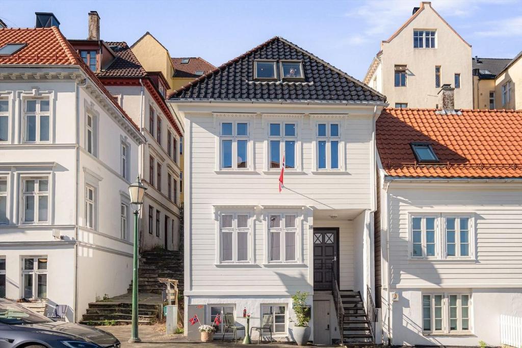 ein weißes Haus in einer Gebäudegruppe in der Unterkunft Nordnes Apartment in Bergen