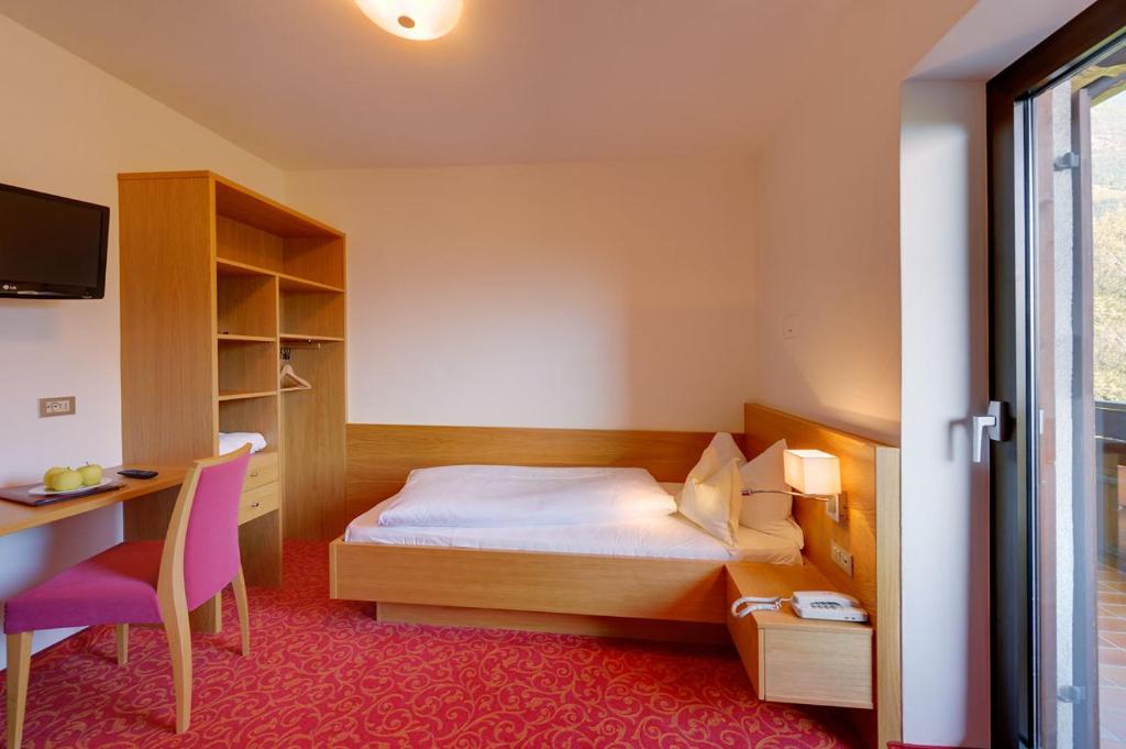 Postel nebo postele na pokoji v ubytování Hotel Laurin