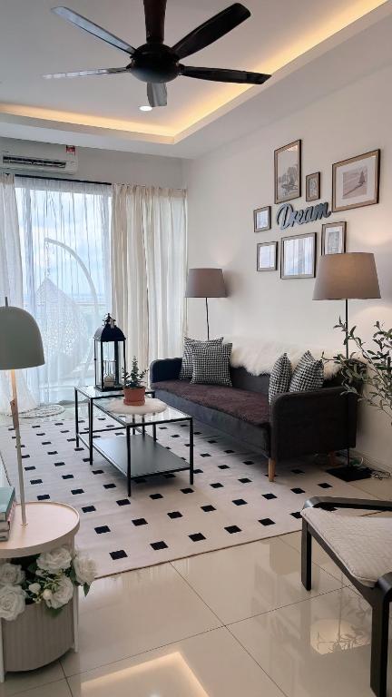 a living room with a couch and a ceiling fan at daisy apartment homestay taiping in Taiping