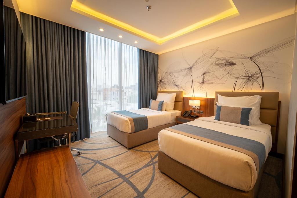 Postel nebo postele na pokoji v ubytování Charli Hotel Jeddah by AHS