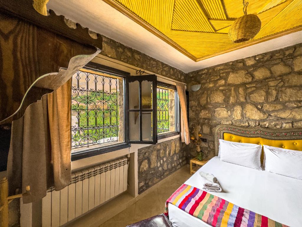 Postel nebo postele na pokoji v ubytování Tonaroz House