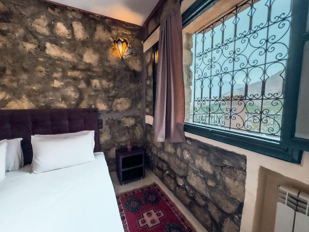 Postel nebo postele na pokoji v ubytování Tonaroz House