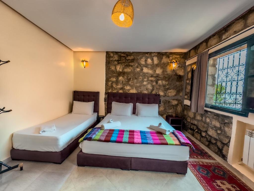Postel nebo postele na pokoji v ubytování Tonaroz House