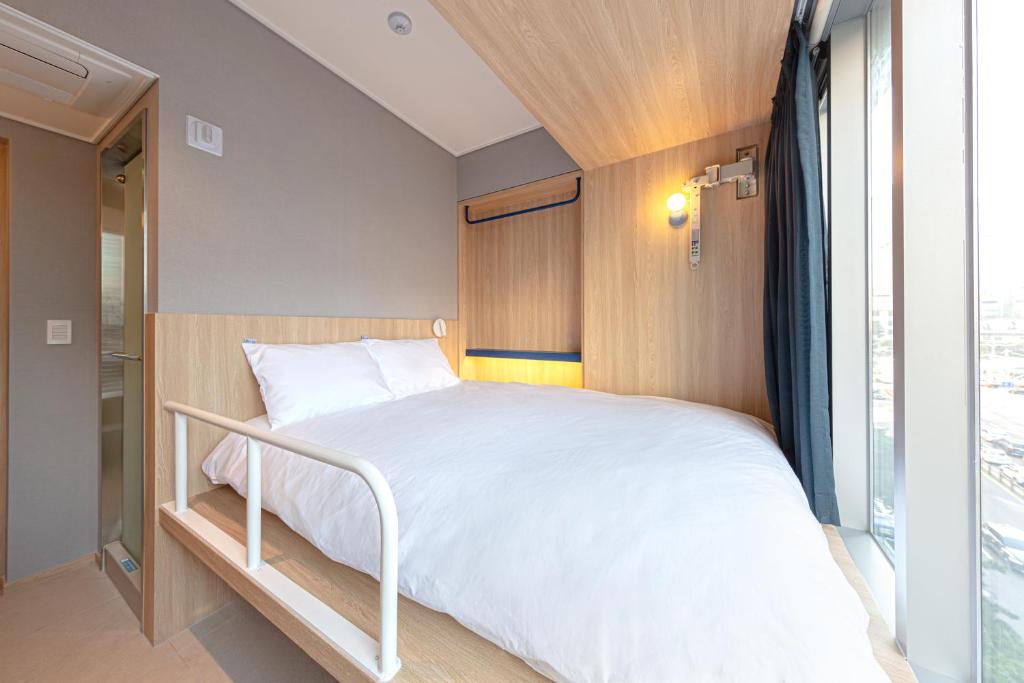 Postel nebo postele na pokoji v ubytování Uhoostay Myeongdong Guesthouse