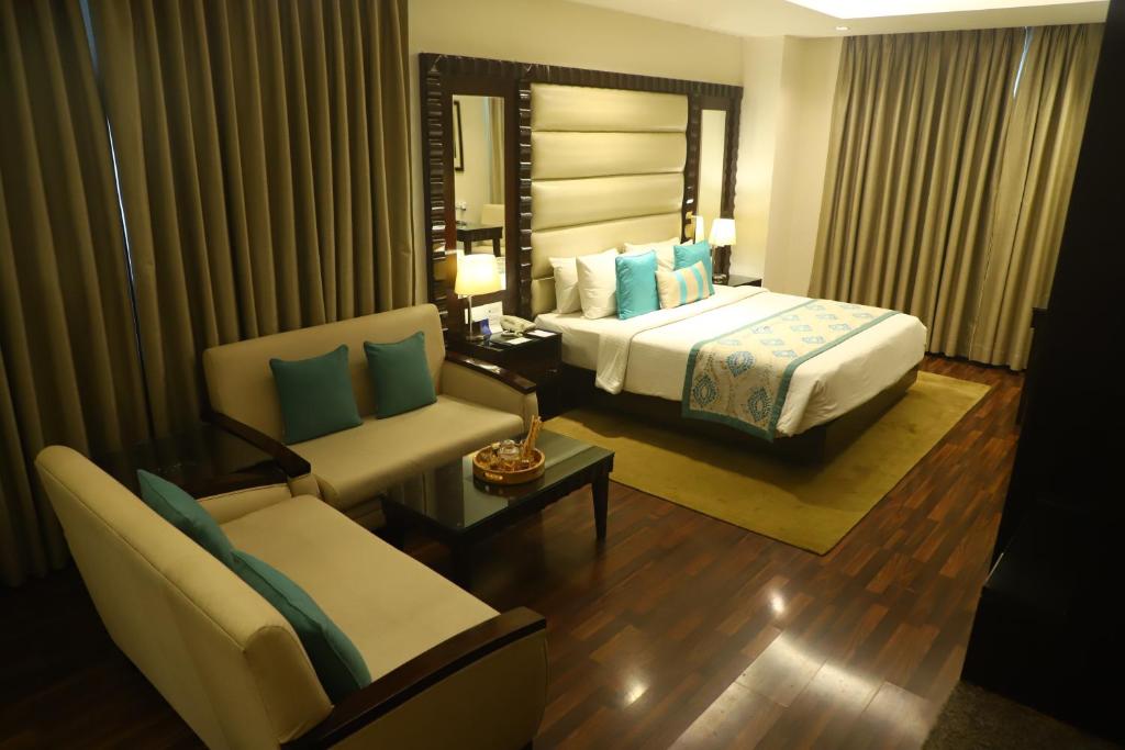 Postel nebo postele na pokoji v ubytování Deventure Sarovar Portico Kapashera, New Delhi