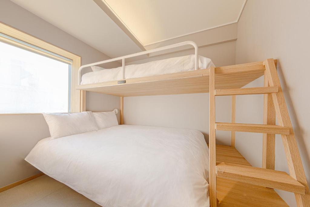 Postel nebo postele na pokoji v ubytování Uhoostay Myeongdong Guesthouse