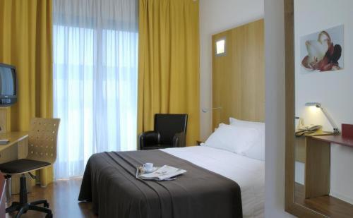 Postel nebo postele na pokoji v ubytování Executive Hotel