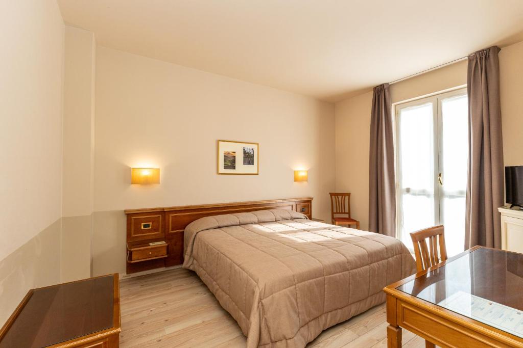 Postel nebo postele na pokoji v ubytování Hotel Valentino