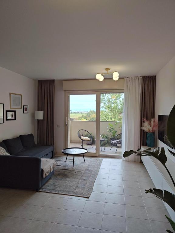 a living room with a couch and a table at Sunset Penthouse in Gessate