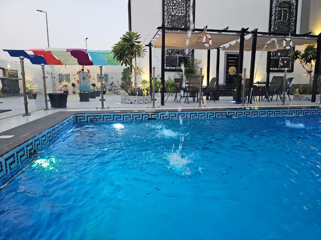 a swimming pool with blue water in a building at مورايا Murraya in Abyār ‘Alī