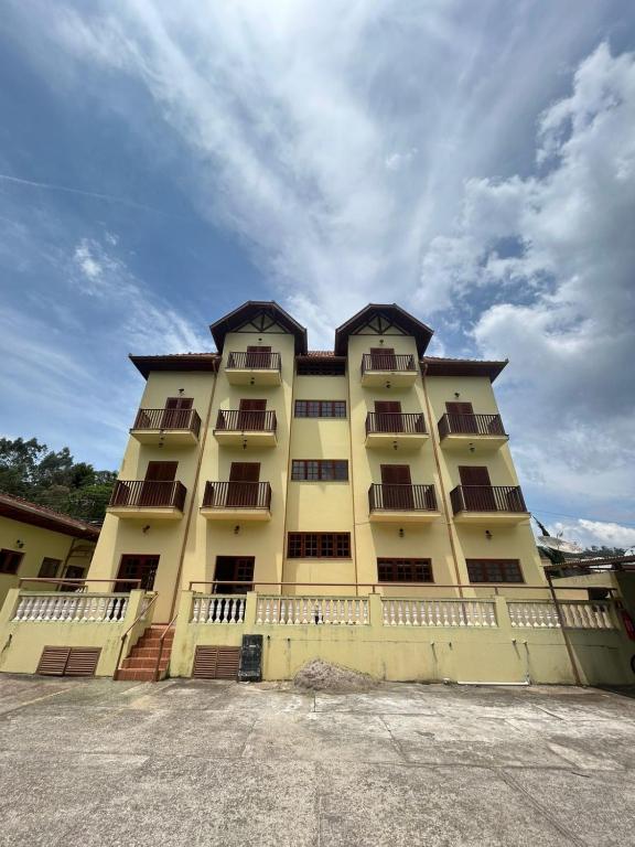 a large yellow building with balconies on it at pousada Boa vista in Santo Antônio do Pinhal