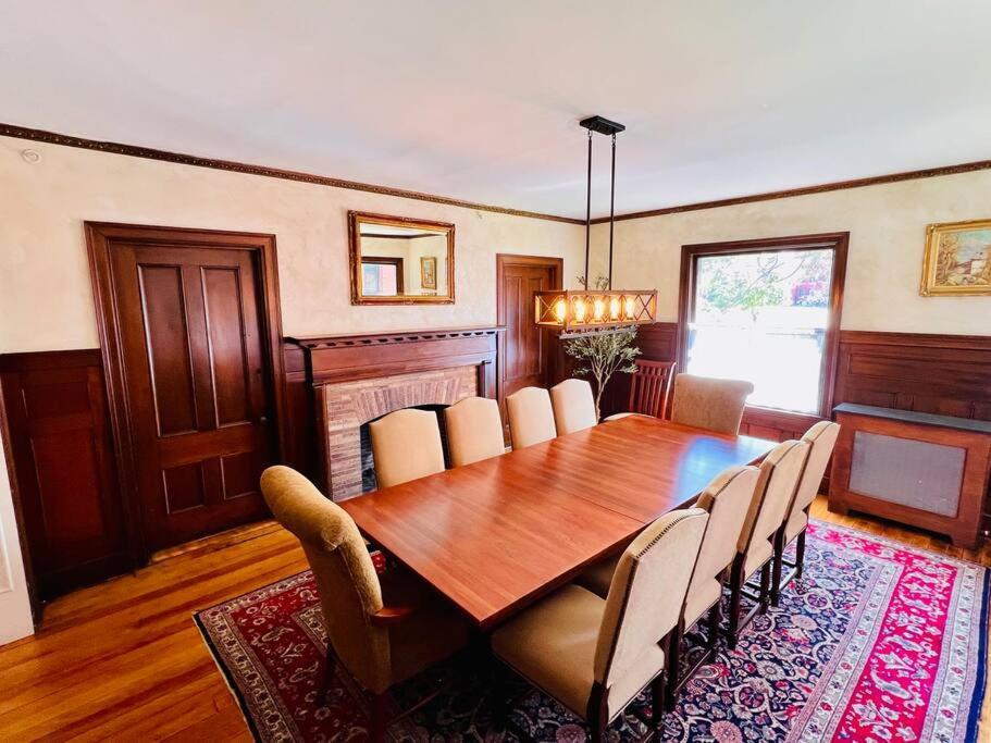 a dining room with a wooden table and chairs at Entire Historic Home in Portland West End in Portland