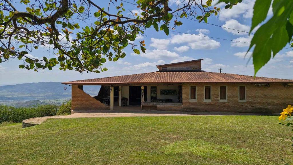 a brick house with a roof on a hill at Solar de Bonito in Bonito