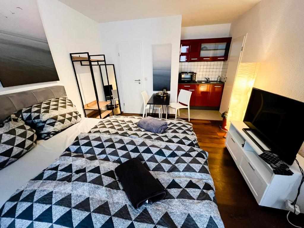 a bedroom with a bed and a television in it at Apartment 1,2,3 in Osnabrück