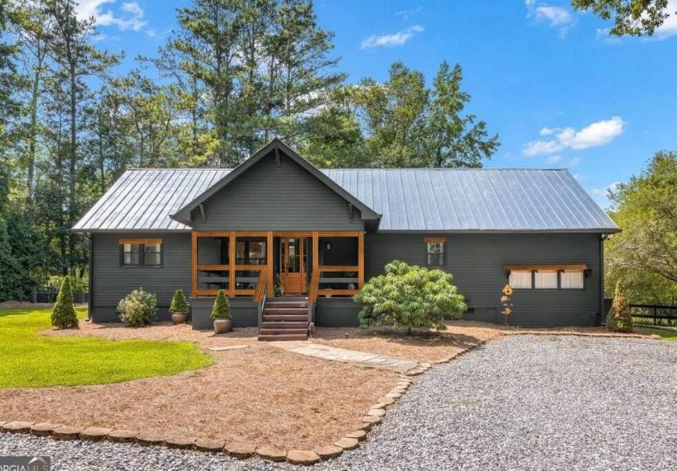 a gray house with a metal roof at Alpharetta Home-5Brooms-6Bds-12Guests in Alpharetta