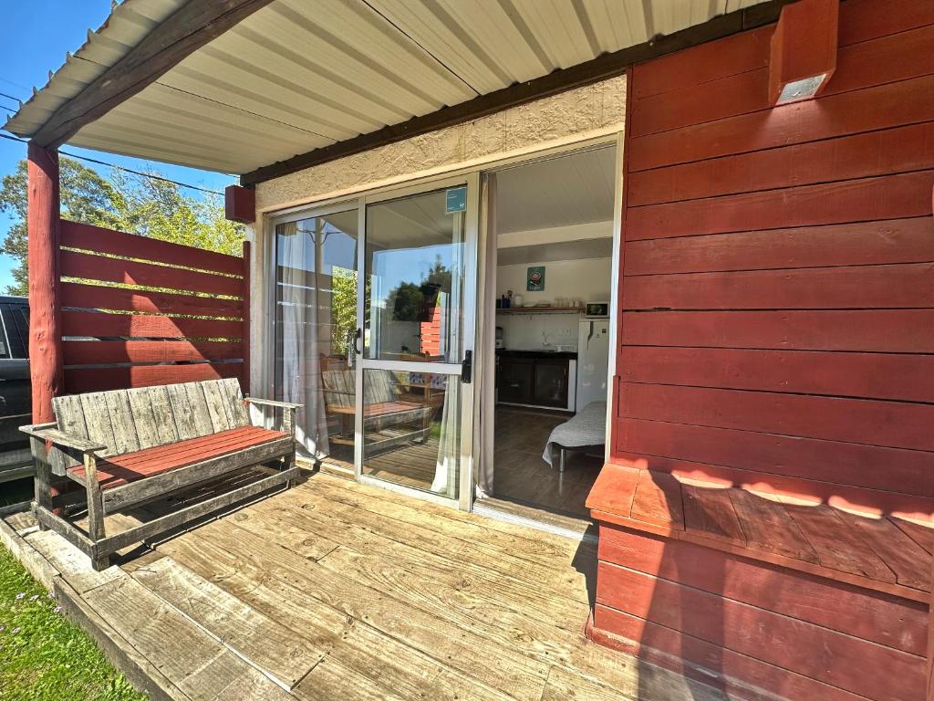 a porch with a bench on the side of a house at Complejo 421 in Piriápolis