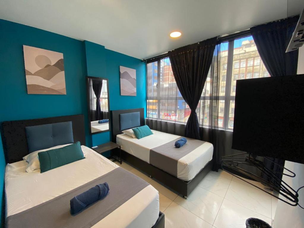 Postel nebo postele na pokoji v ubytování Hotel HILLS BOGOTA
