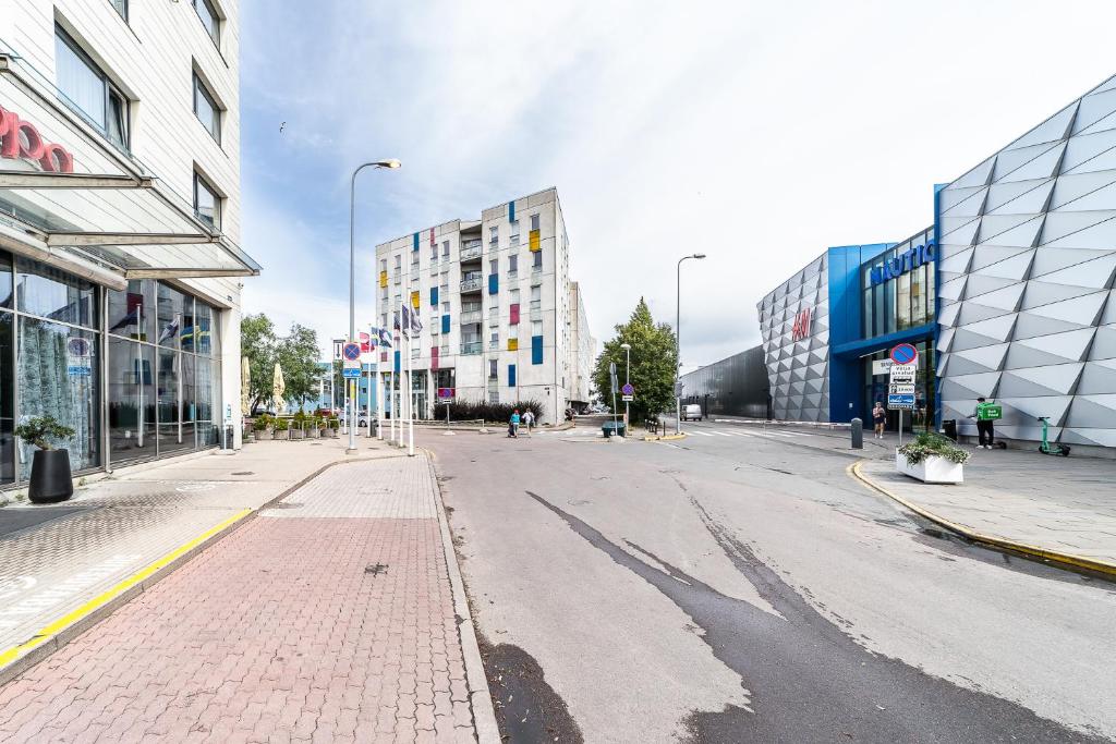 an empty street in a city with tall buildings at Top floor near ferry terminal - free parking in Tallinn