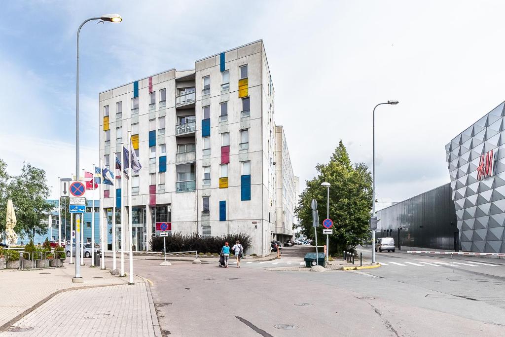 a large white building with colorful squares on it at Top floor near ferry terminal - free parking in Tallinn