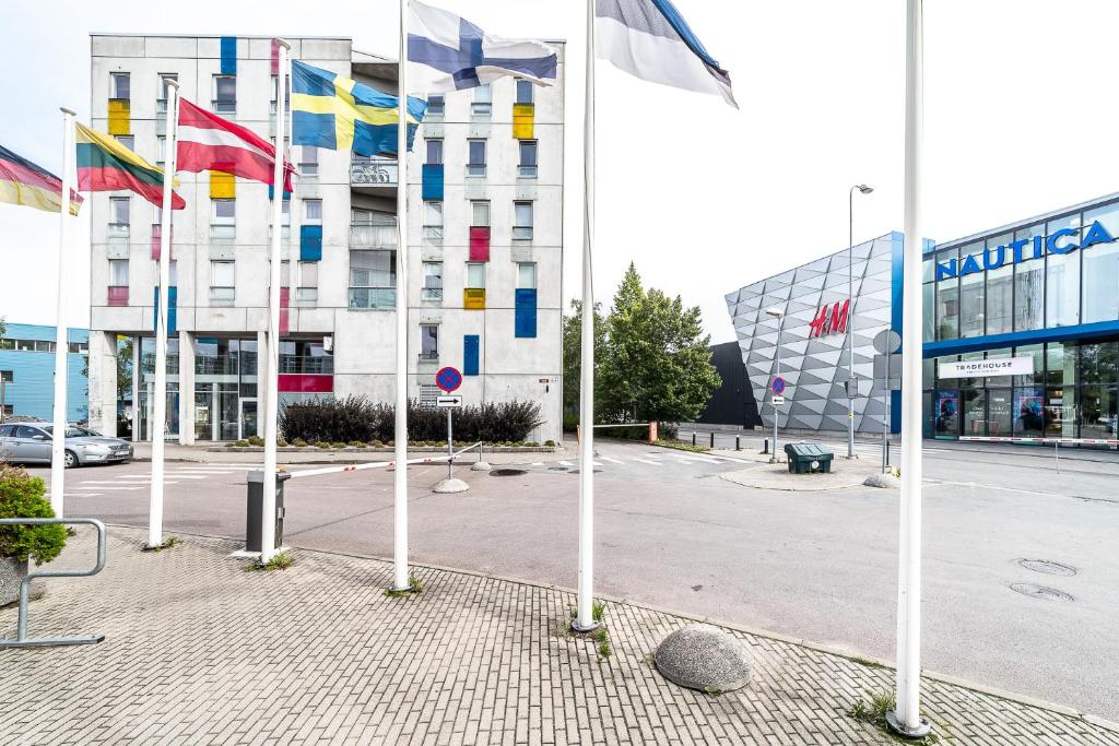 a group of flags in front of a building at Top floor near ferry terminal - free parking in Tallinn