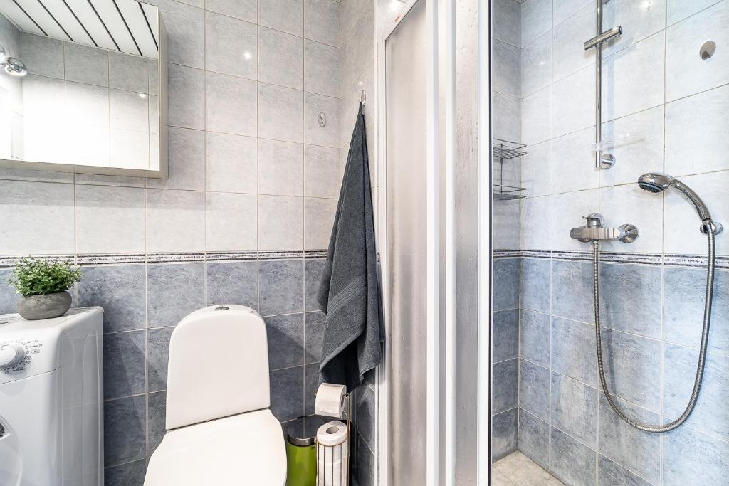 a bathroom with a shower and a toilet in it at Top floor near ferry terminal - free parking in Tallinn