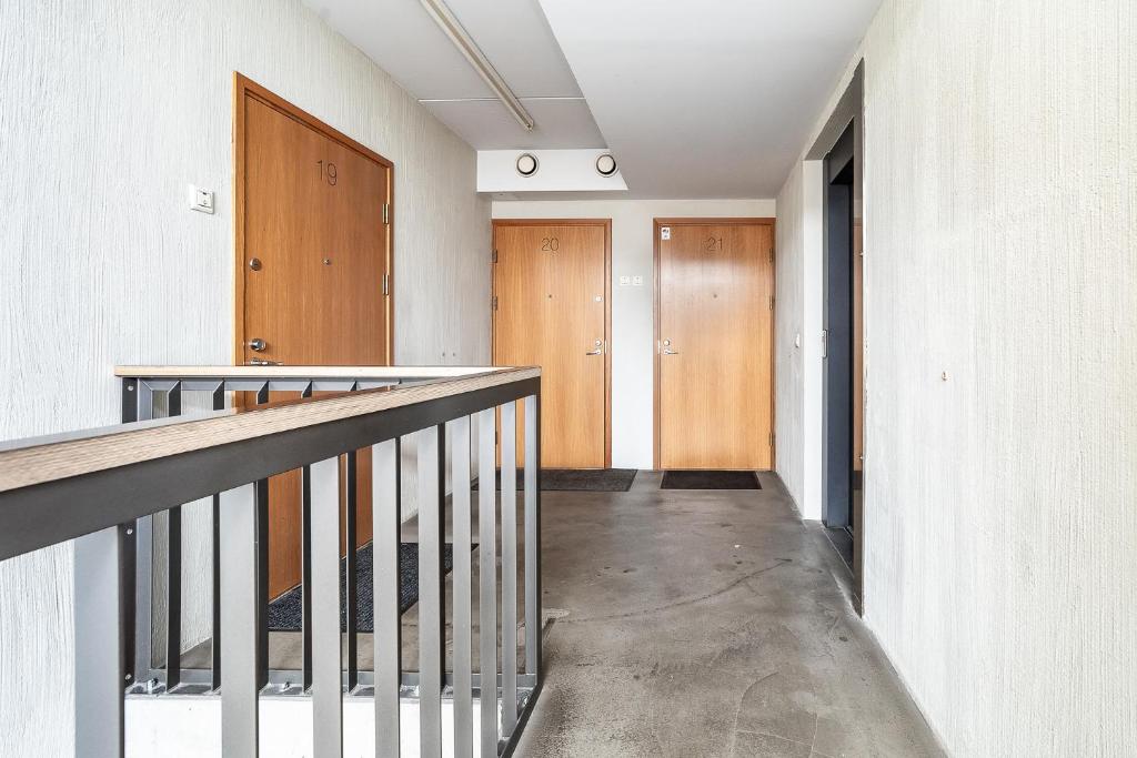a hallway of a building with a staircase and wooden doors at Top floor near ferry terminal - free parking in Tallinn