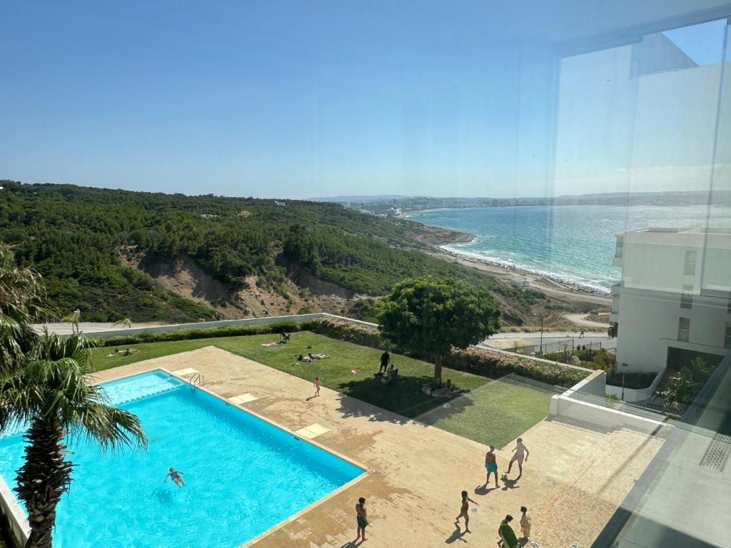 a view of a swimming pool and the ocean at Meditranee Sea View in Tangier