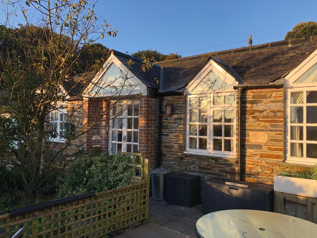 a brick house with windows and a patio at The Nook in Padstow