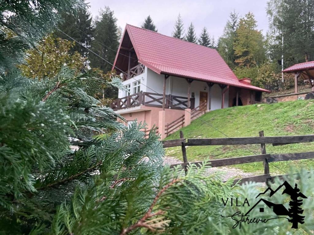 a house with a red roof and a fence at Vila Starcevic in Pale
