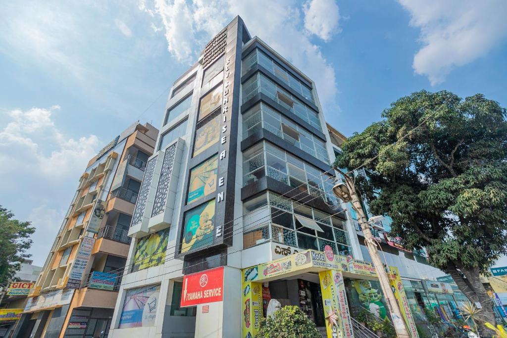 a tall building on a city street at Collection O Indian Suites Near Sitara Restaurant in Bengaluru