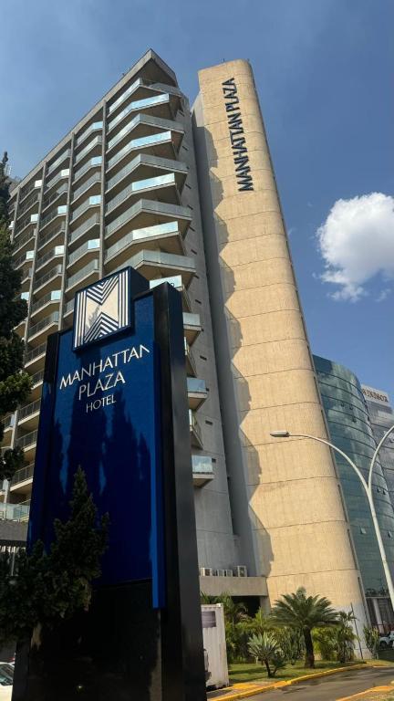 a tall building with a sign in front of it at MANHATTAN - JK APART Hotel in Brasilia