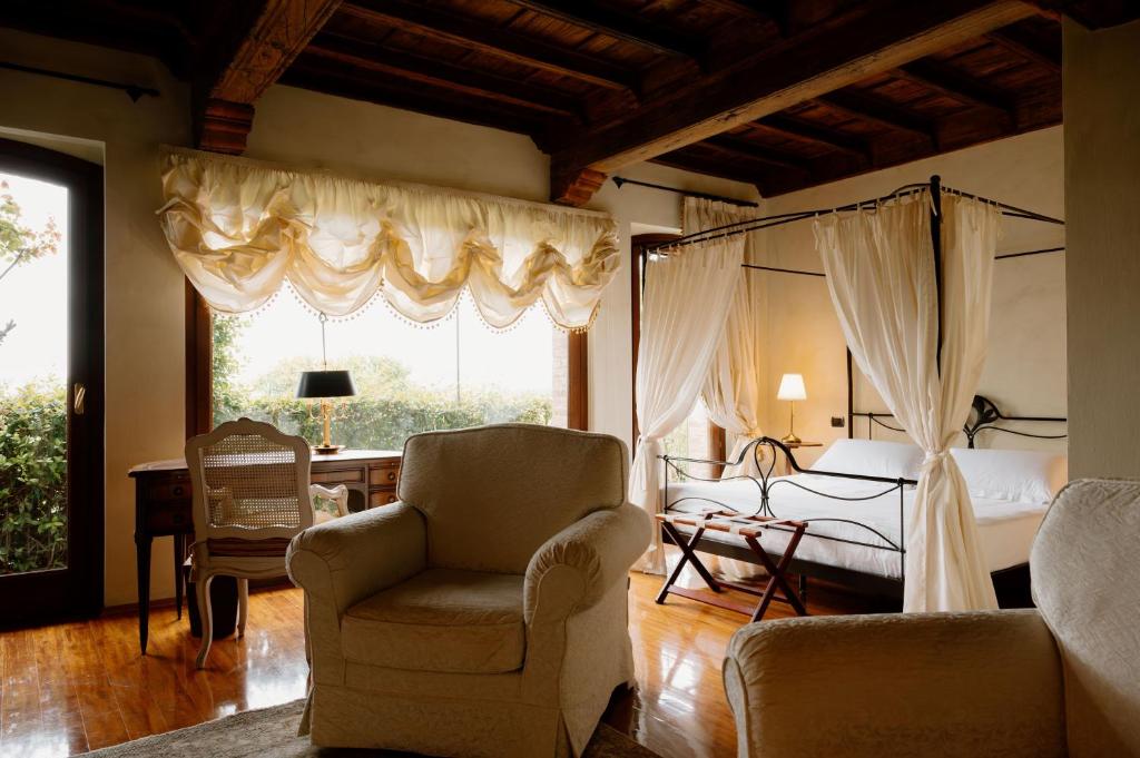 una camera con letto, scrivania e sedia di Hotel Casa Pavesi a Grinzane Cavour