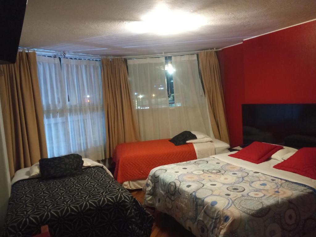 Postel nebo postele na pokoji v ubytování Hostal Capri