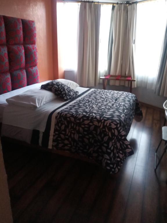 Postel nebo postele na pokoji v ubytování Hostal Capri