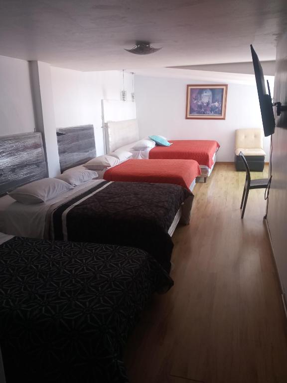 Postel nebo postele na pokoji v ubytování Hostal Capri