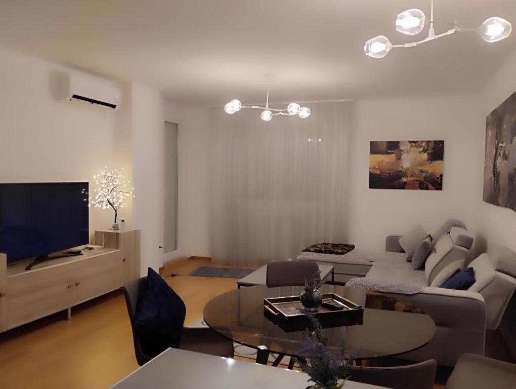 a living room with a couch and a table at Loft Lux in Banja Luka