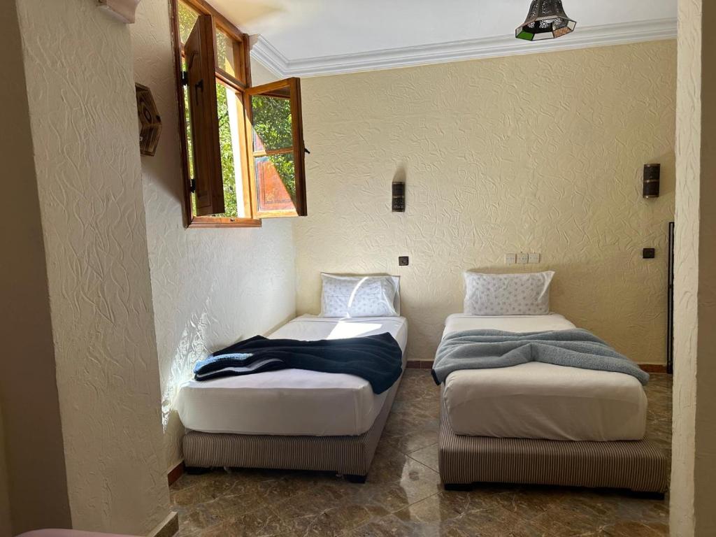 Postel nebo postele na pokoji v ubytování Kasbah Imoula