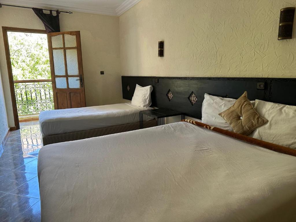 Postel nebo postele na pokoji v ubytování Kasbah Imoula