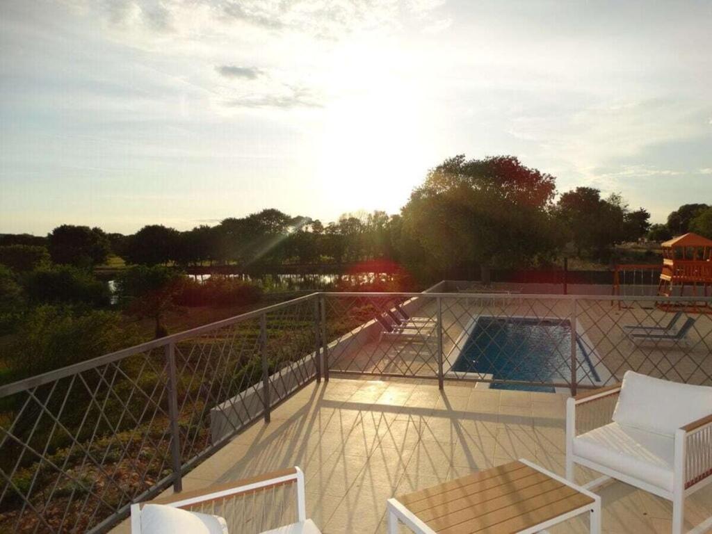 a balcony with a view of a swimming pool at Bagulina Comfortable holiday residence in Drniš
