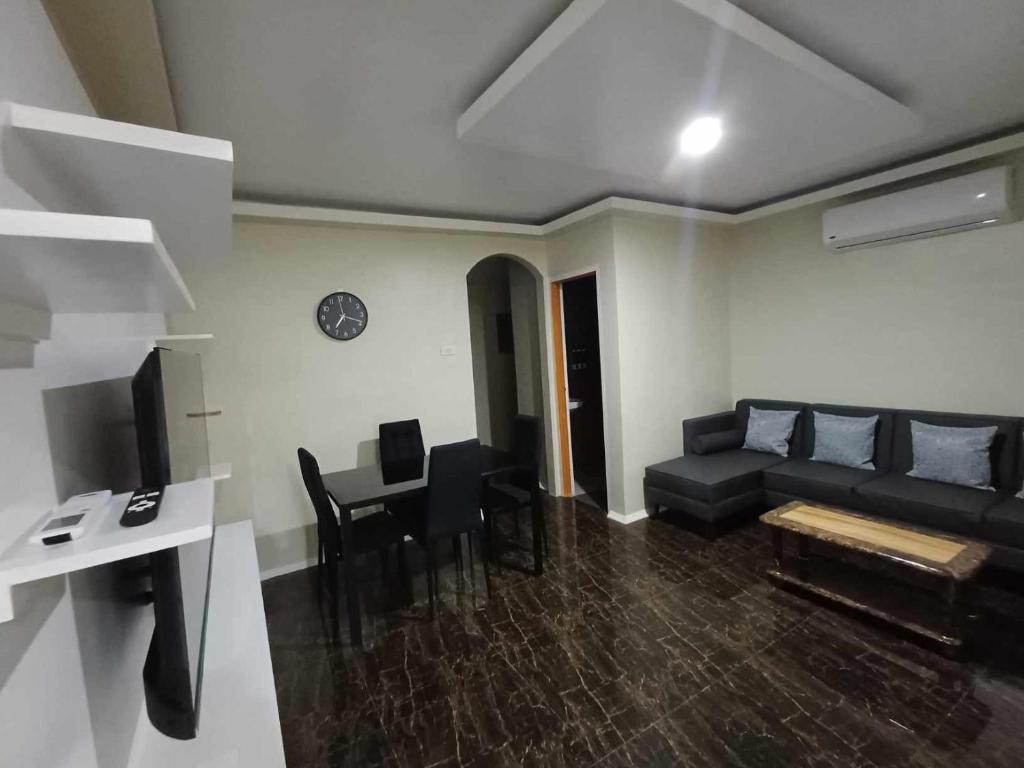 a living room with a couch and a table at Catrionna Palace in La Filipina