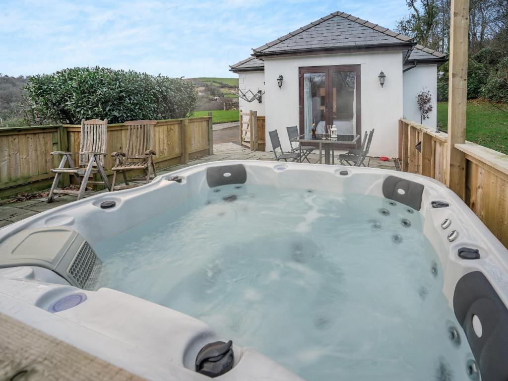 a large hot tub in the backyard of a house at Bay Cottage in Tondu