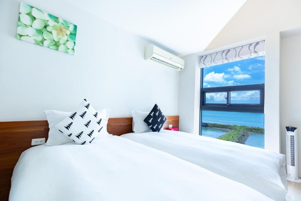 Postel nebo postele na pokoji v ubytování 野居海景渡假民宿Simple Life Home Stay