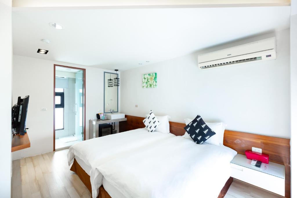Postel nebo postele na pokoji v ubytování 野居海景渡假民宿Simple Life Home Stay