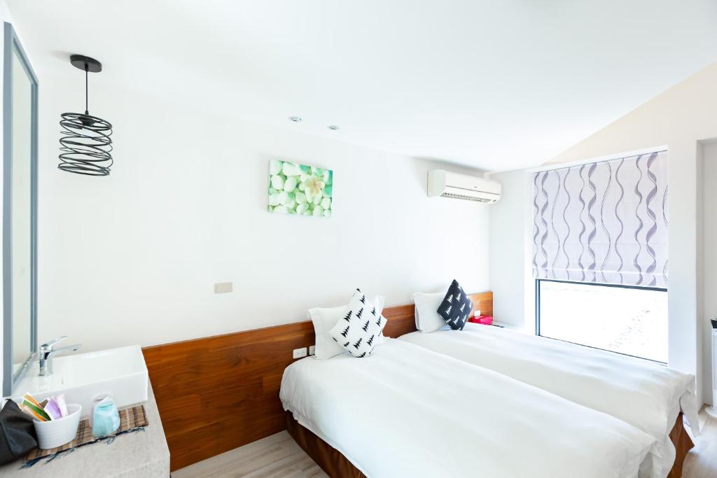 Postel nebo postele na pokoji v ubytování 野居海景渡假民宿Simple Life Home Stay