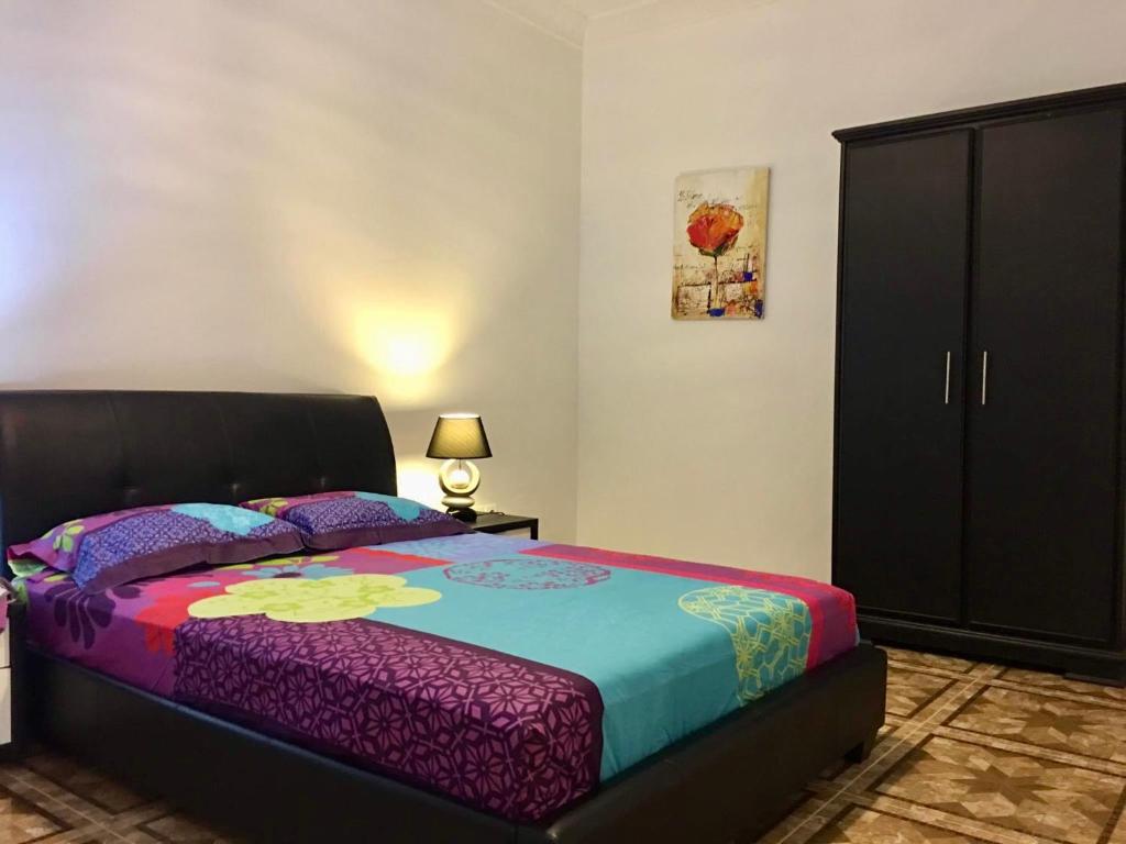 a bedroom with a large bed and a black cabinet at Appart Clim Wifi 700m de la Plage in Saïdia