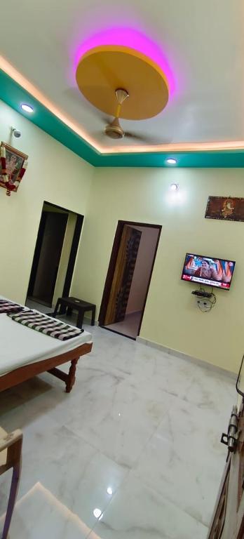 a room with a ceiling with a tv on the wall at Mallikarjun Residency with AC in Akalkot