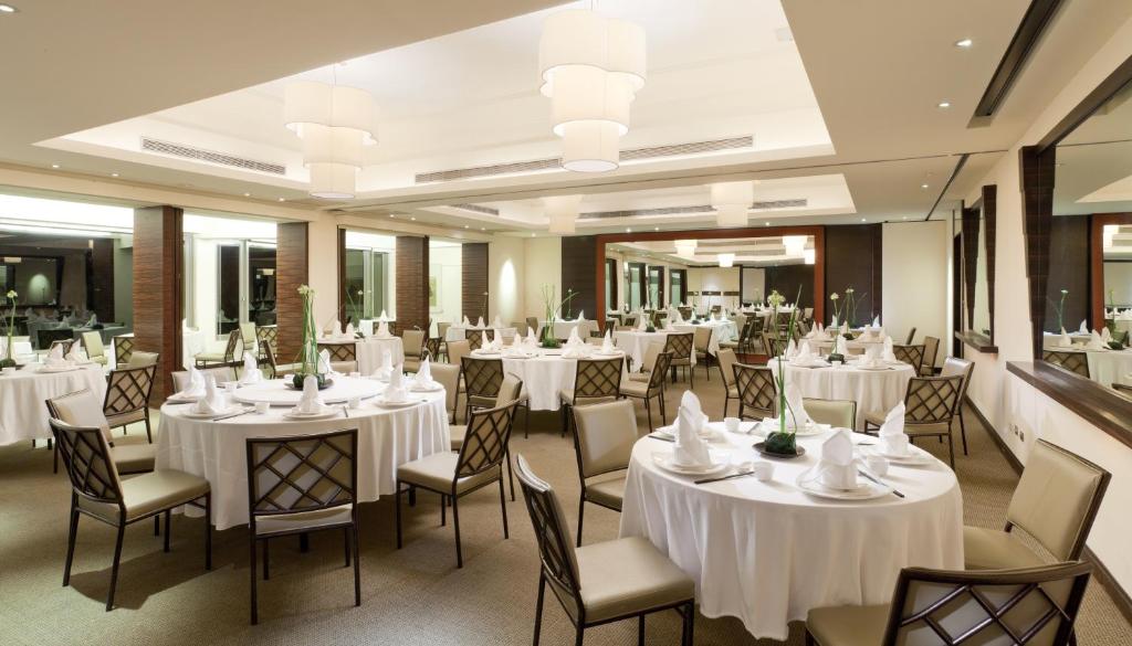 a banquet hall with white tables and chairs at CHECK inn Select Taipei Yamgmingshan in Taipei