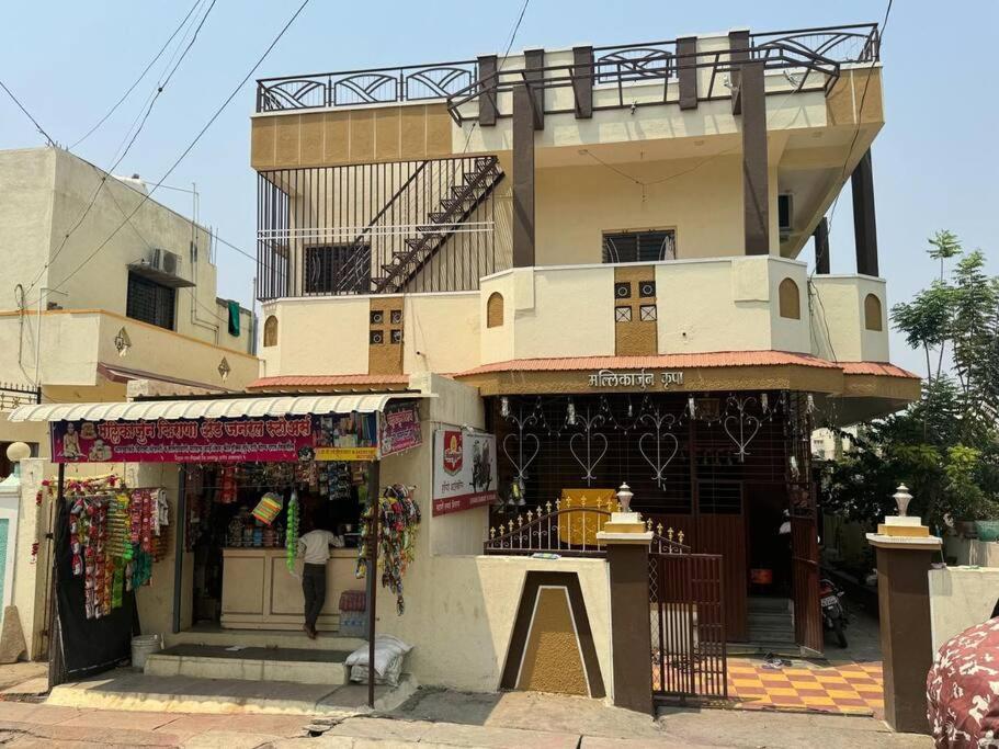 a building with a store in front of it at Mallikarjun Residency in Akalkot