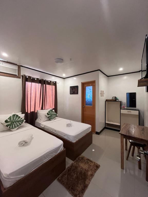 Postel nebo postele na pokoji v ubytování ISLANDERS INN - CORON