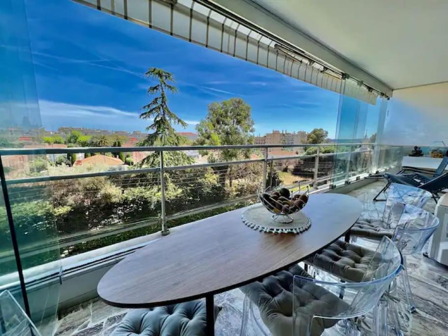 une salle à manger avec une table et des chaises et une grande fenêtre dans l'établissement Grande terrasse vue dégagée mer en Basse Californie, à Cannes